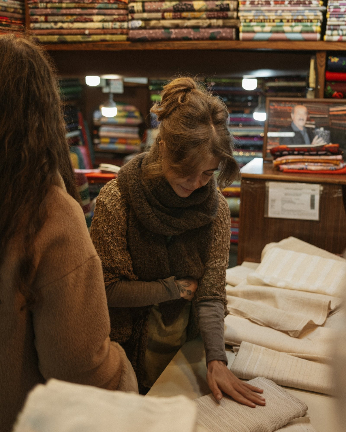 Jamy choosing natural fabrics at a textile shop